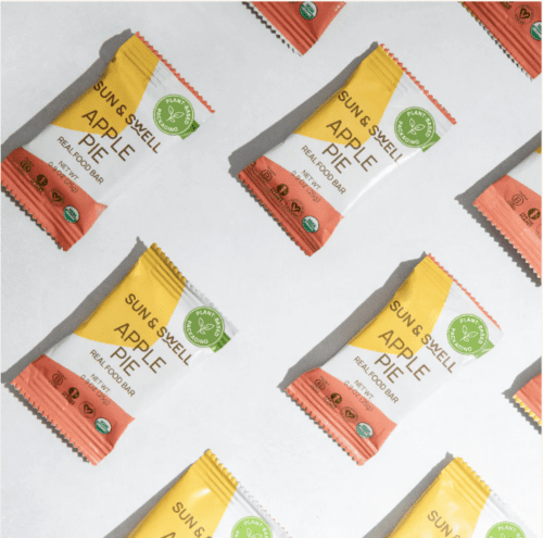 Sun & Swell Apple Pie Real Food Bar, 0.9 oz, organic ingredients including dates, cashews, dried apples, gluten-free oats, and cinnamon, plant-based packaging, ideal for a healthy snack.